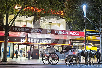 Melbourne, Australia - October 17,2013 : white horse drawn carriage in front of burger shop Editorial Stock Photo