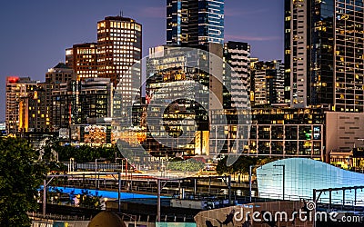 Melbourne skyline at dusk with riverside quay buildings at night in Melbourne Australia Stock Photo