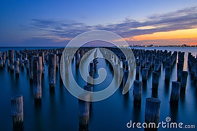 View of Princess pier with old wooden structures at sunset Stock Photo