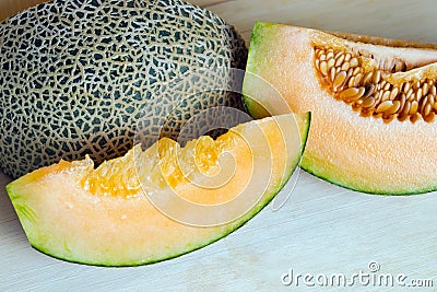 Melon or cantaloupe sliced on wooden board with seeds (Also call Stock Photo