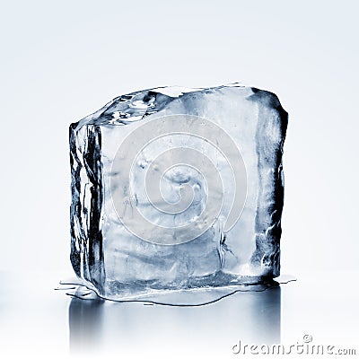 Melting cold blue ice block with reflection Stock Photo