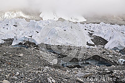 Melting ice glaciers due to global warming with thick mist at the top Stock Photo