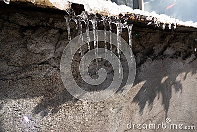 Melting icicles on a building Stock Photo