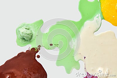 Multicolored pattern of melted ice cream on a white background with copy space. Top view Stock Photo