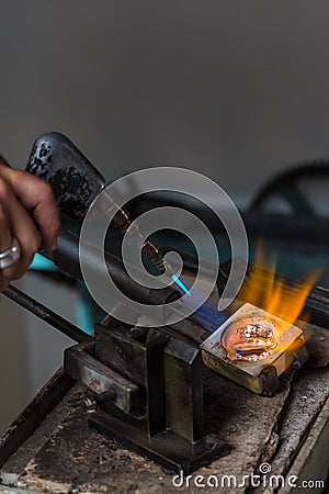 Melting Silver Grains in crucible with blowtorch Stock Photo