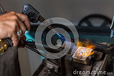 Melting Silver Grains in crucible with blowtorch Stock Photo