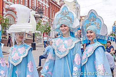 Members of dance groups in national costumes at the festive procession of graduates of schools Editorial Stock Photo