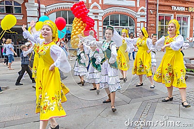 Members of dance groups in national costumes at the festive procession of graduates of schools Editorial Stock Photo