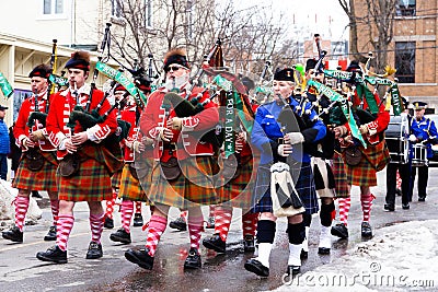 Members of the 78th Fraser Highlanders bagpipers participating in the St. Patrick parade in downtown Quebec City Editorial Stock Photo