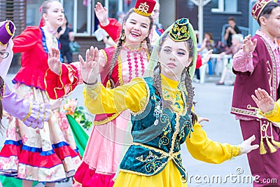 Members of theater groups in national costumes at the festive procession of graduates of schools Editorial Stock Photo