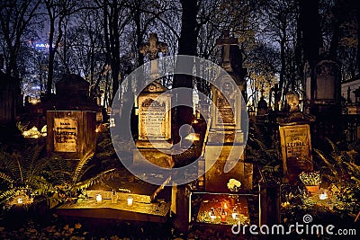 Memento mori - lights and graves on All Saints` Day in the Powazki Cemetery Polish: Cmentarz Powazkowski - is a historic Editorial Stock Photo