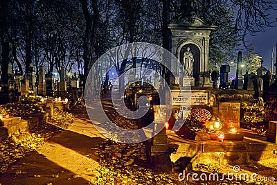 Memento mori - lights and graves on All Saints` Day in the Powazki Cemetery Polish: Cmentarz Powazkowski - is a historic Editorial Stock Photo