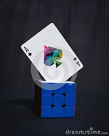 Memento mori playing card on a blue cube against a dark background. Stock Photo