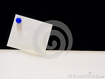 Memo paper with blue magnet on black and white background Stock Photo