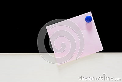 Memo pink paper with blue magnet on black and white background Stock Photo