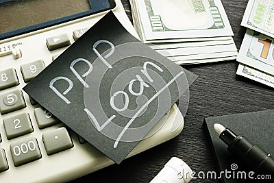 Memo sign PPP Loan Paycheck Protection Program on the black piece of paper Stock Photo