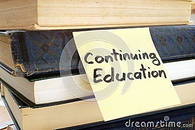 Memo stick with words Continuing education. Stock Photo