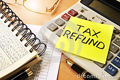 Memo stick with words tax refund. Stock Photo