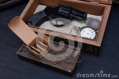 Memorabilia - old vintage revolver gun with ammunitions in wooden box for letters Stock Photo