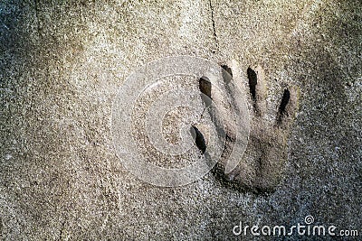 Memorable handprint of a hand in an old concrete wall Stock Photo