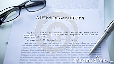Memorandum lying on table, pen and eyeglasses on official document, business Stock Photo