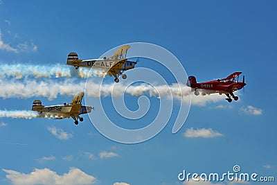 Memorial Airshow, Bucker Jungmeister in flight, smoke effect Editorial Stock Photo