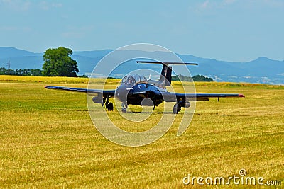 Memorial Airshow. Czech L29 advanced jet traning aircraft. Landing at a grassy airport. Editorial Stock Photo