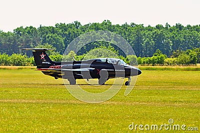 Memorial Airshow. Czech L29 advanced jet traning aircraft. Landing at a grassy airport. Editorial Stock Photo