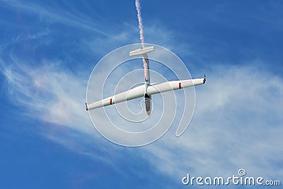 Memorial Airshow. Flying Glider aerobatic team withlight sailplane showing his performance, smoke effect Editorial Stock Photo