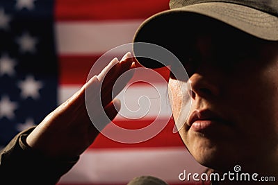 Memorial day. A female soldier in uniform salutes against the background of the American flag. Close-up portrait. The concept of Stock Photo