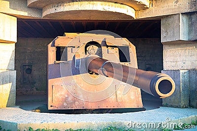 Gun emplacement at Omaha Beach. Bomb shelter with german long-range artillery gun from world war 2 in Longues-sur-Mer in Normandy. Stock Photo