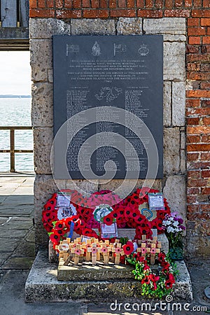 The memorial to the Falklands war dead at The Hotwalls in old Portsmouth with poppy wreaths laid in front of it Editorial Stock Photo