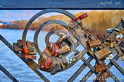 Memory locks on the bridge over the Ulba river - strange, amazing, unusual view of the empty streets of spring Ust-Kamenogorsk due Editorial Stock Photo