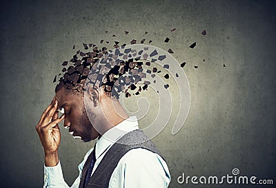 Side profile of a sad man losing parts of head as symbol of decreased mind function. Stock Photo