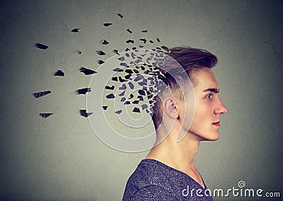 Memory loss due to dementia or brain damage. Man losing parts of head as symbol of decreased mind function. Stock Photo