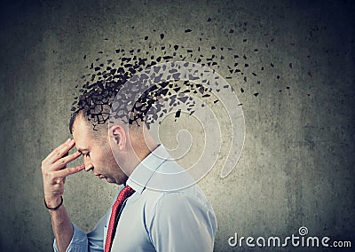 Side profile of a sad man losing parts of head as symbol of decreased mind function Stock Photo