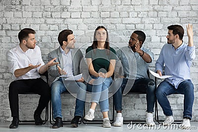 Men applicants wait for job interview show disrespect for girl Stock Photo