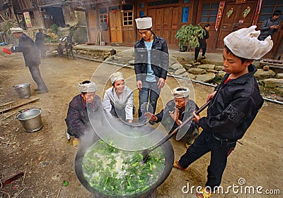 Men Asians, Chinese peasants, farmers, cook on rural street vil Editorial Stock Photo