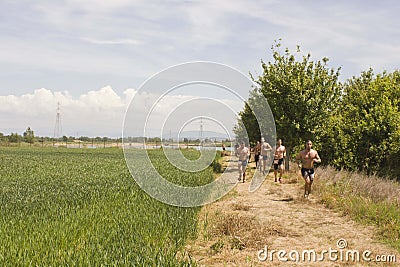 Men with bare breast running in a field Editorial Stock Photo