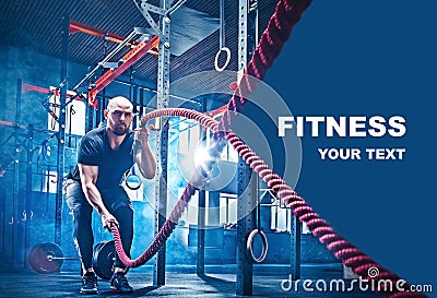 Men with battle rope battle ropes exercise in the fitness gym. Stock Photo