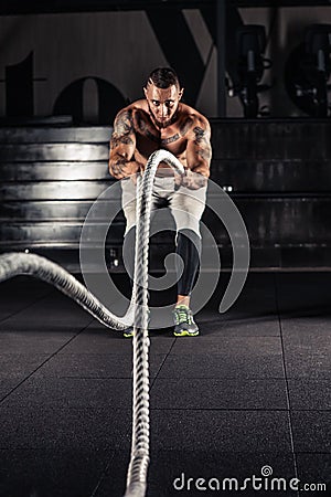 Men with battle ropes exercise Stock Photo