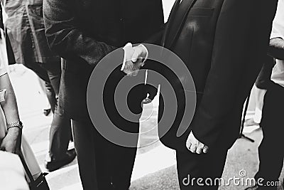 Men in black suits shake each other hands Stock Photo