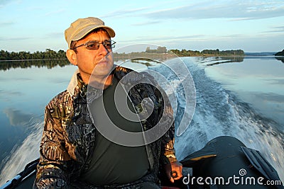Men on boat with motor Stock Photo