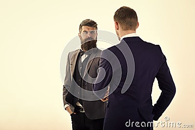 Men in classic suits, businessmen, business partners meeting, white background, isolated. Businessmen shaking hands Stock Photo
