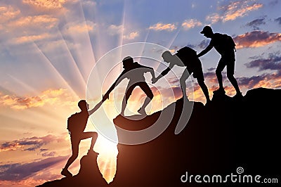Men climbers help each other in the mountains Stock Photo