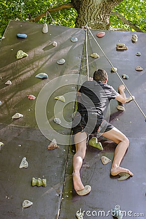 Men climbing on a wall Stock Photo