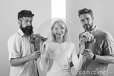 Men competitors with bouquets flowers try conquer girl. Girl smiling reject gifts. Out of relations. Feminism concept Stock Photo