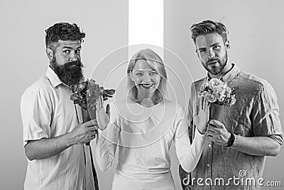 Men competitors with bouquets flowers try conquer girl. Girl smiling reject gifts. Out of relations. Girl popular Stock Photo