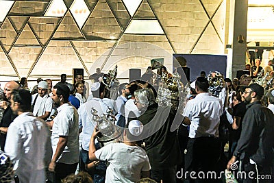 Men dance with Bible scrolls during the ceremony of Simhath Torah. Tel Aviv. Israel Editorial Stock Photo