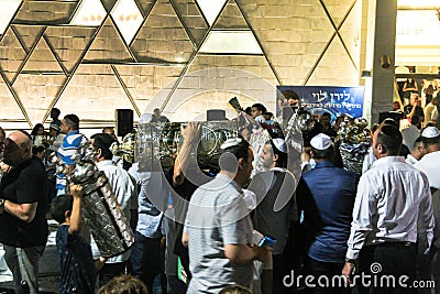Men dance with Bible scrolls during the ceremony of Simhath Torah. Tel Aviv. Israel Editorial Stock Photo
